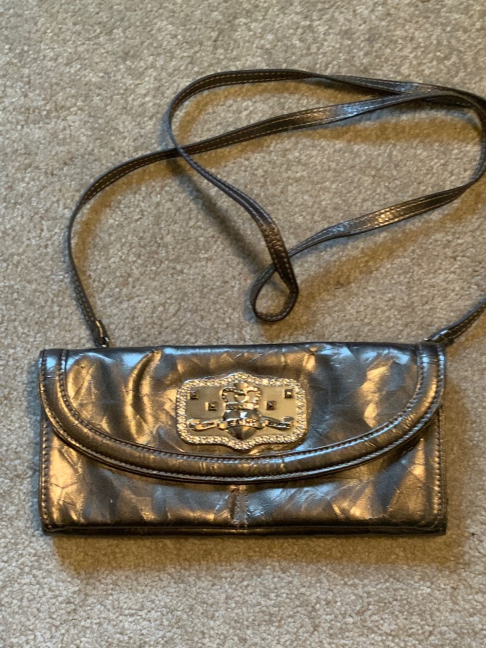 Kathy Van Zeeland Metallic Gray Crossbody Clutch with Crest Emblem